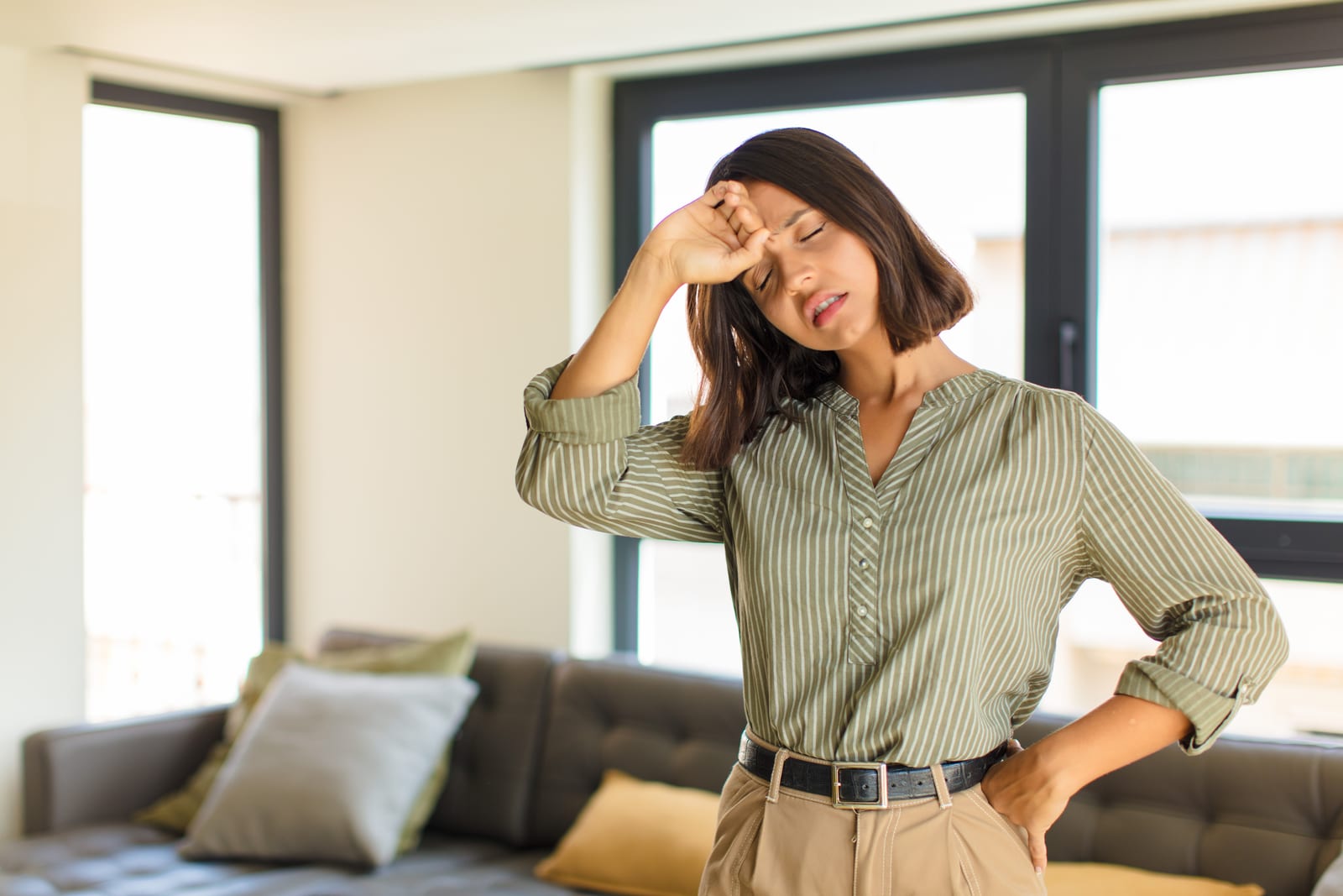 Tired, stressed woman at home touching her forehead, fatigue and difficulty getting pregnant
