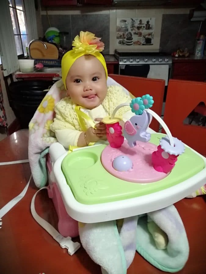 Baby Arleth in a high chair