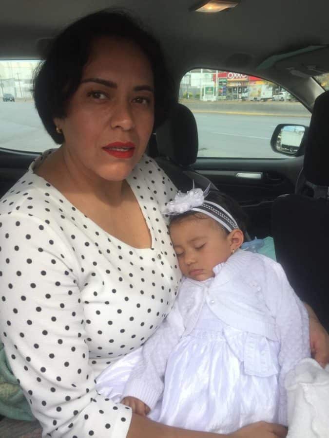 Carolina holding Cielo after the baptism
