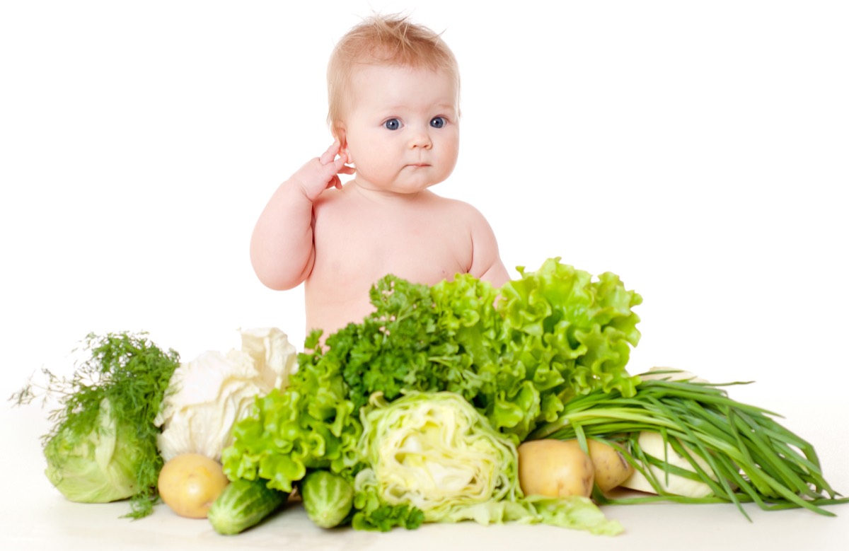 Baby surrounded by fresh vegetables, illustrating the nutritional intervention of Ingenes Metabolic Medicine