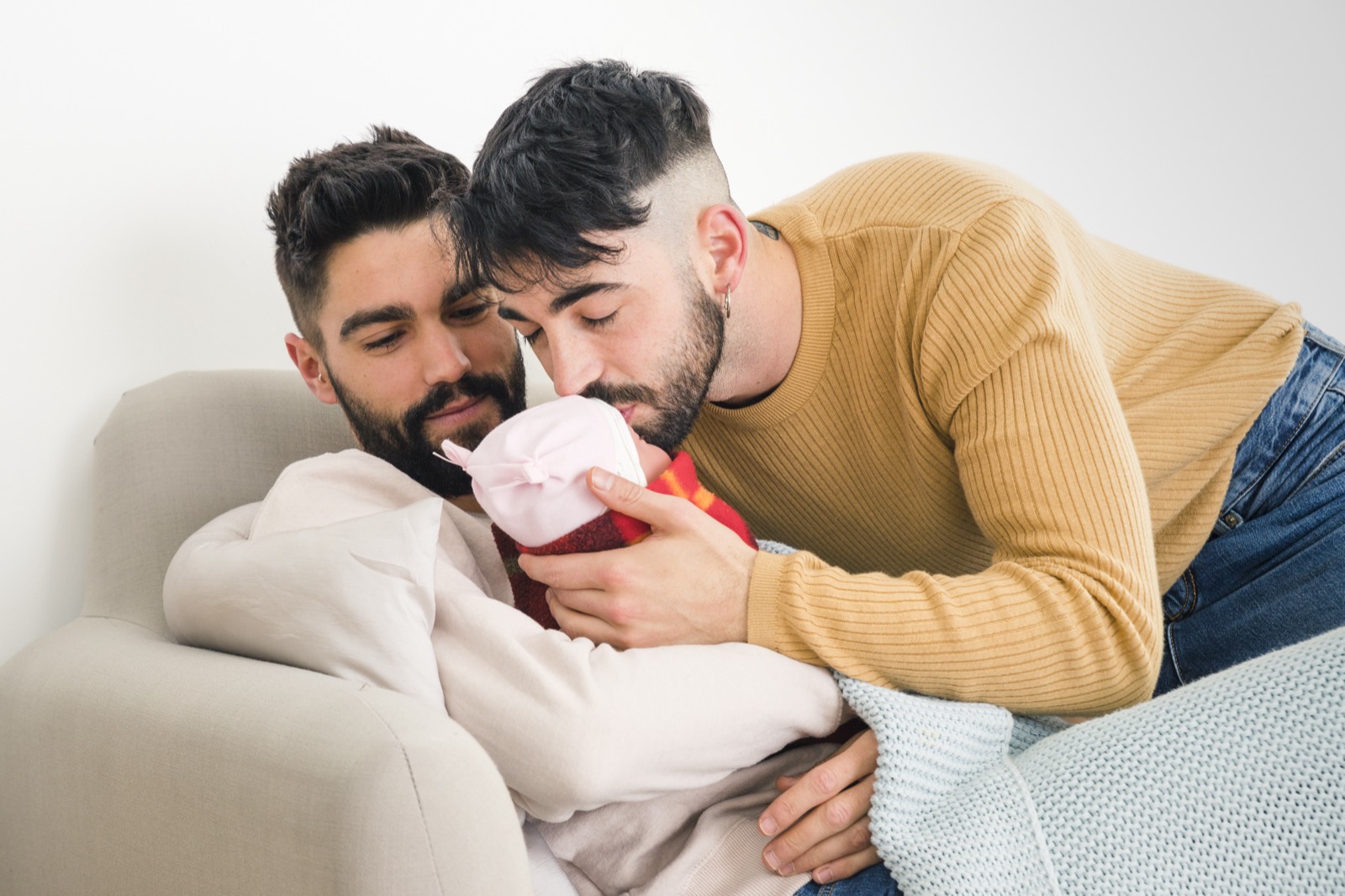 Two dads with their baby after a gestational surrogacy program at Ingenes, legal and regulated in Mexico